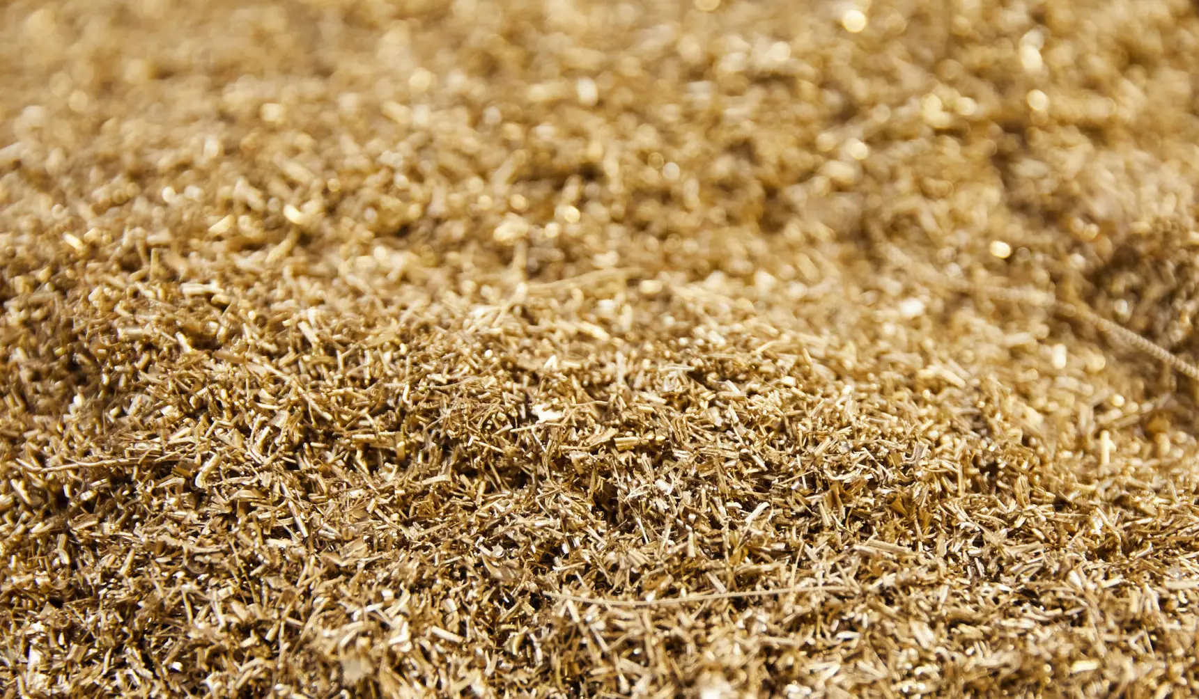 A close up of the ground that is made out of straw.