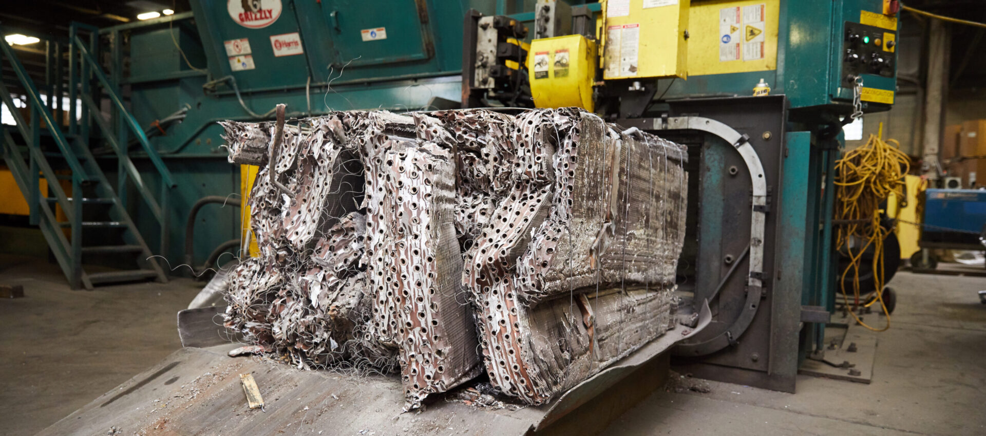 A truck with many pieces of newspaper stacked on top.